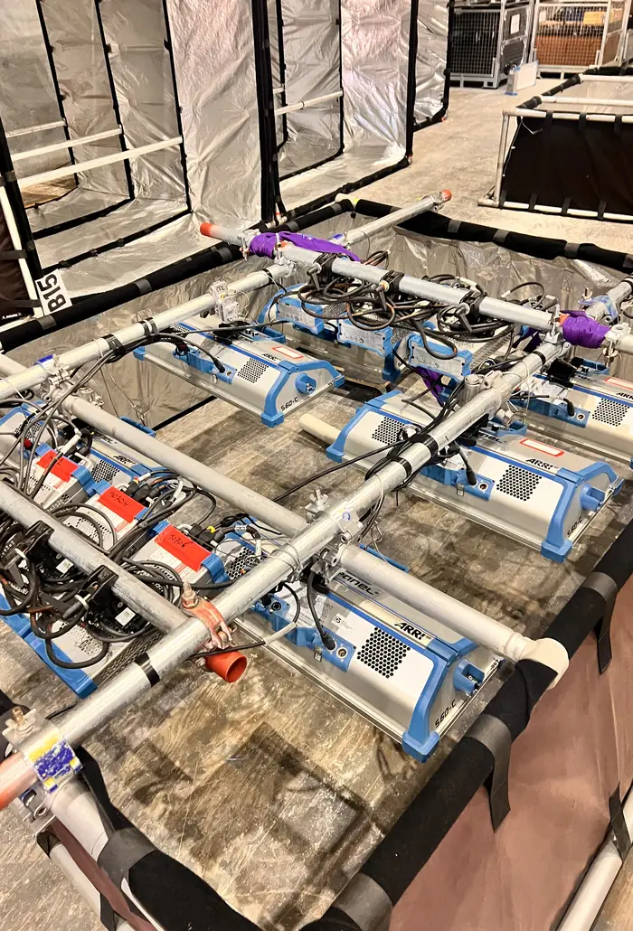 Rows of rigged LED fixtures laid out on the studio floor before a build