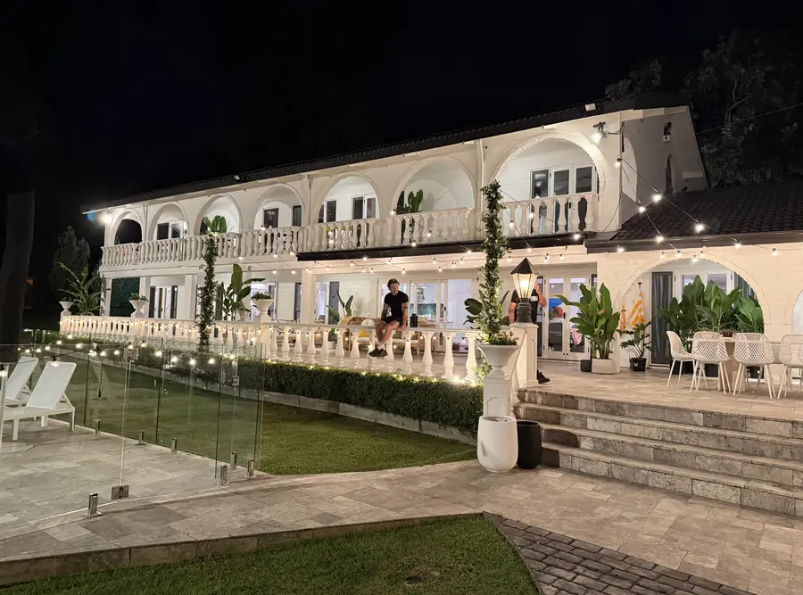 Night exterior of a villa set lit with warm practicals