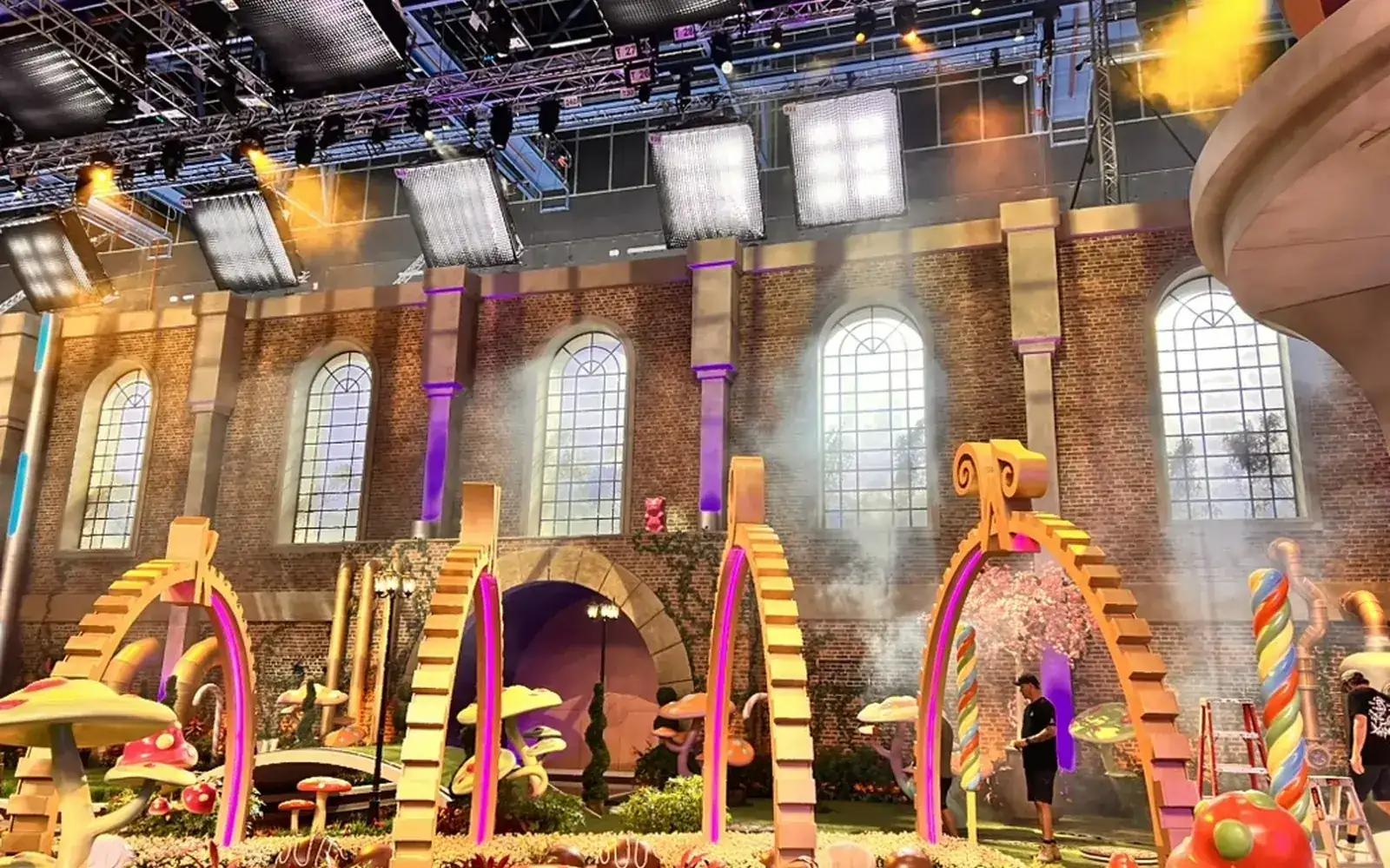 The chocolate room of Wonka's The Golden Ticket: candy arches and brick walls under a full grid of soft LED sources